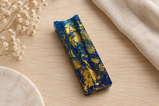 Blue and gold resin V-block rolling cradle shown flat with V-groove channel visible