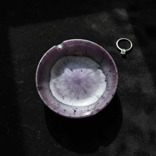 Purple metallic petri burst round resin ashtray shown flat on a dark surface with a silver ring