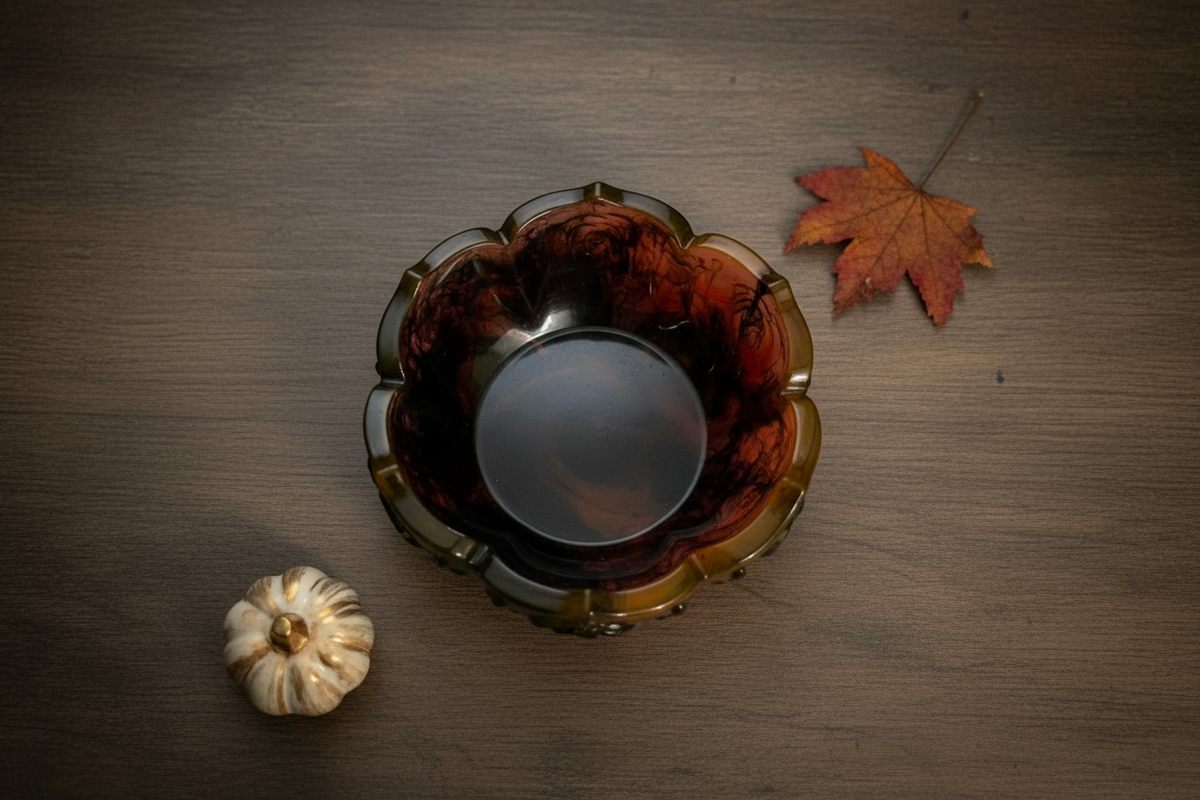 Black and orange Halloween rose lotus resin trinket bowl styled in a flat-lay scene
