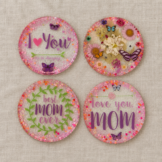 Four Love You Mom floral resin coasters arranged in a grid on linen